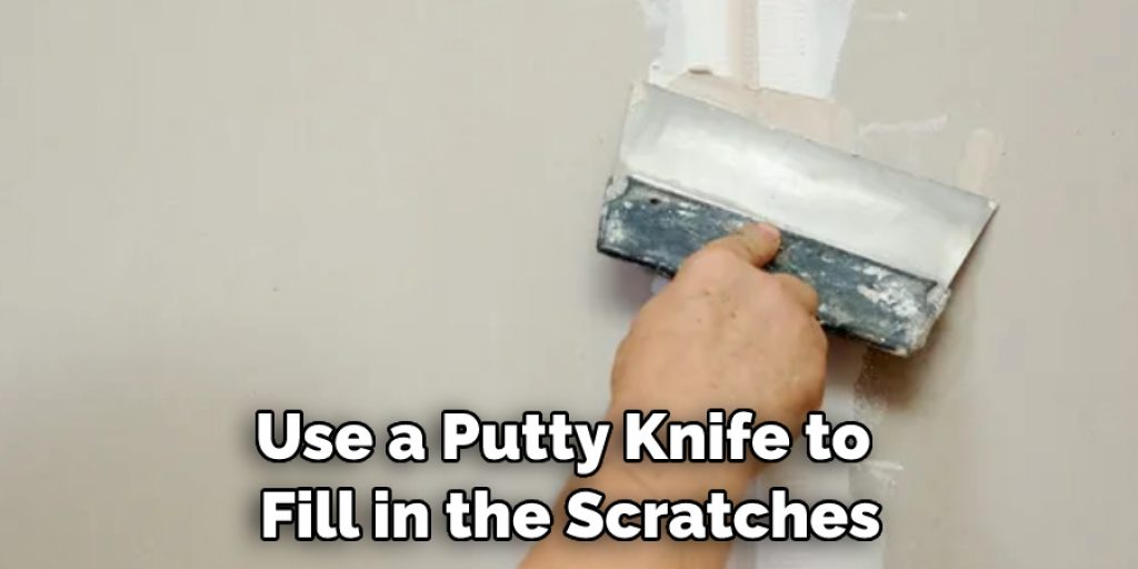 Use a Putty Knife to  Fill in the Scratches